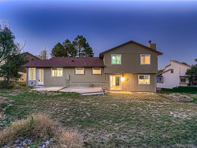 8916 Sunridge Hollow Rd, Parker, CO 80134 - rear view of house with a lawn, a patio, and a chimney