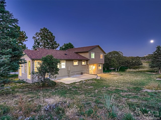 8916 Sunridge Hollow Rd, Parker, CO 80134 - back of house featuring roof with shingles, a yard, and a patio area