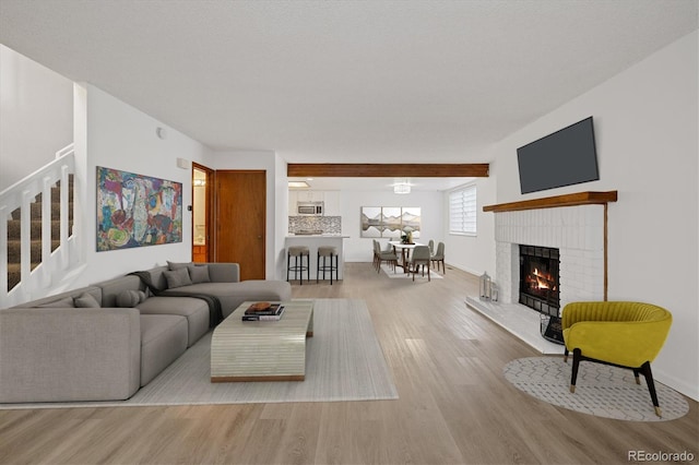 1770 S Quintero Way, Aurora, CO 80017 - living area featuring baseboards, wood finished floors, a fireplace, and stairs