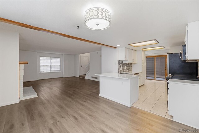 1770 S Quintero Way, Aurora, CO 80017 - kitchen with a peninsula, white cabinetry, open floor plan, and light countertops