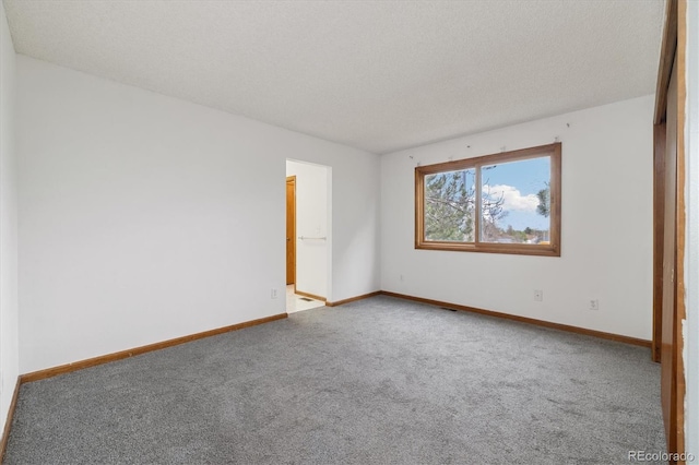1770 S Quintero Way, Aurora, CO 80017 - spare room featuring baseboards, carpet flooring, and a textured ceiling