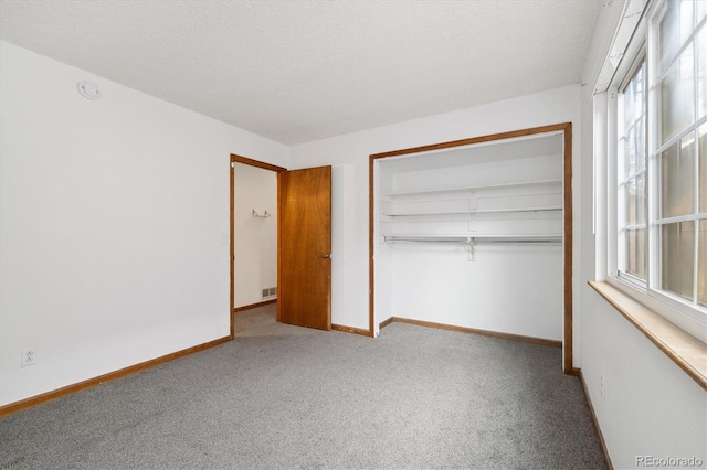 1770 S Quintero Way, Aurora, CO 80017 - unfurnished bedroom with baseboards, multiple windows, a closet, and carpet