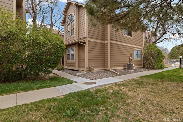 1770 S Quintero Way, Aurora, CO 80017 - view of home's exterior with a lawn and central AC