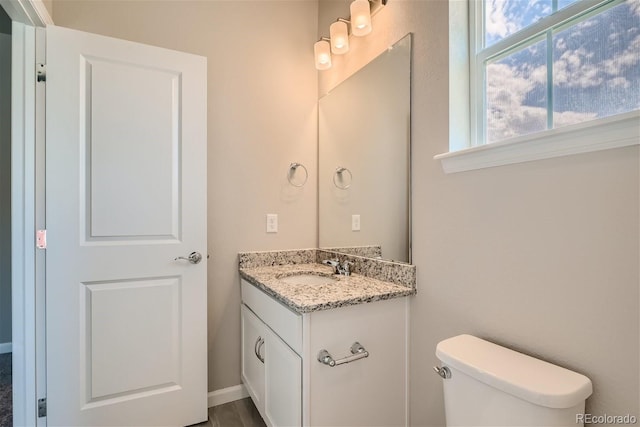 bathroom featuring vanity and toilet