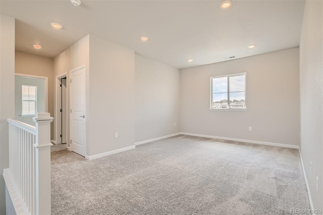 unfurnished room with light colored carpet