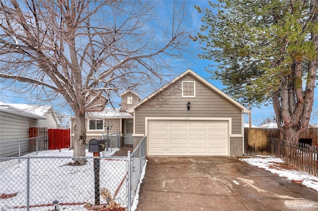 view of front of property featuring a garage, fence private yard, and concrete driveway