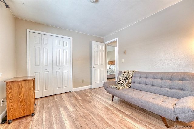 sitting room featuring light wood-style flooring and baseboards