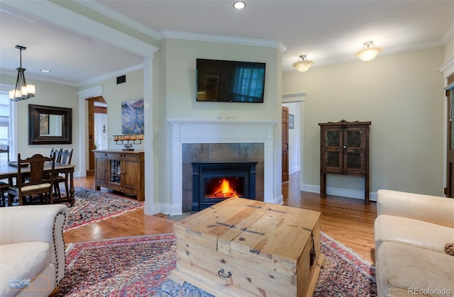 3737 26th St, Boulder, CO 80304 - living room with a fireplace, wood finished floors, crown molding, recessed lighting, and a chandelier