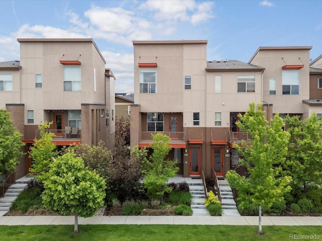 8336 E 35th Ave, Denver, CO 80238 - rear view of property with stucco siding and stairs