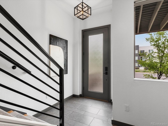 8336 E 35th Ave, Denver, CO 80238 - foyer entrance featuring stairway, baseboards, and tile patterned flooring