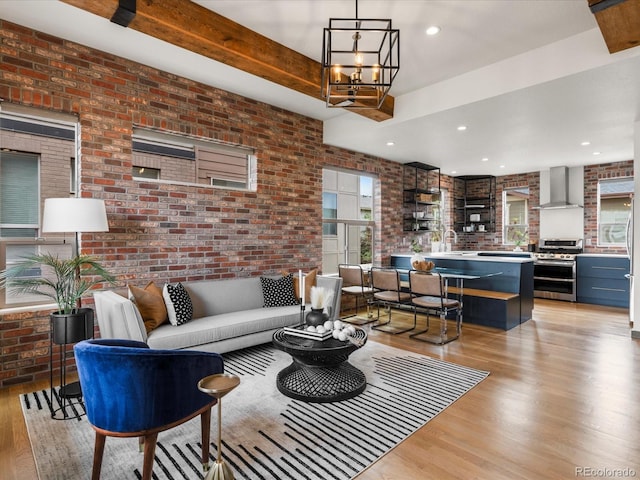 8336 E 35th Ave, Denver, CO 80238 - living area with brick wall, light wood finished floors, and a chandelier