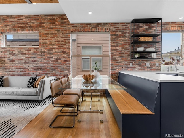 8336 E 35th Ave, Denver, CO 80238 - dining room featuring brick wall, wood finished floors, and recessed lighting