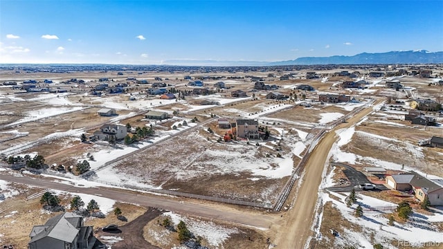 snowy aerial view featuring a mountain view