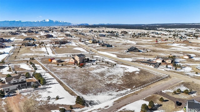 snowy aerial view featuring a mountain view