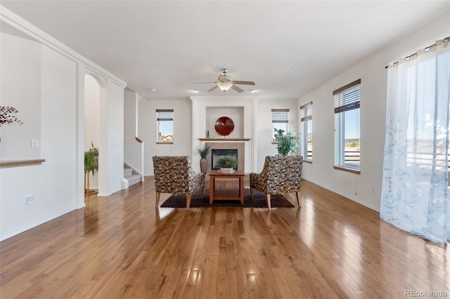 living area with ceiling fan and light hardwood / wood-style floors