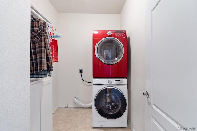 laundry room with stacked washer / drying machine