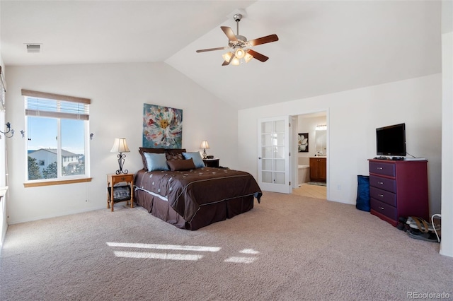 bedroom with lofted ceiling, ensuite bathroom, light carpet, and ceiling fan