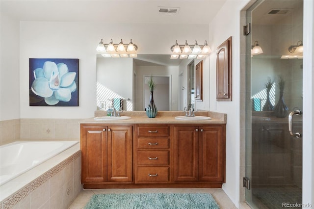 bathroom with vanity, tile patterned floors, and plus walk in shower