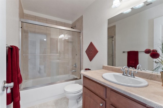 full bathroom featuring toilet, combined bath / shower with glass door, and vanity