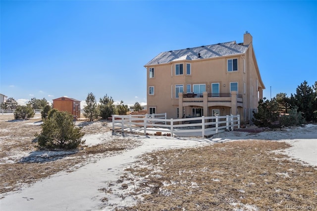 snow covered property featuring a balcony