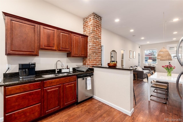 kitchen with a sink, dark wood-style flooring, a peninsula, and dishwasher