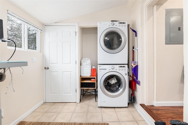 3220 W 24th Ave, Denver, CO 80211 - washroom featuring electric panel, laundry area, light tile patterned flooring, stacked washer and dryer, and baseboards