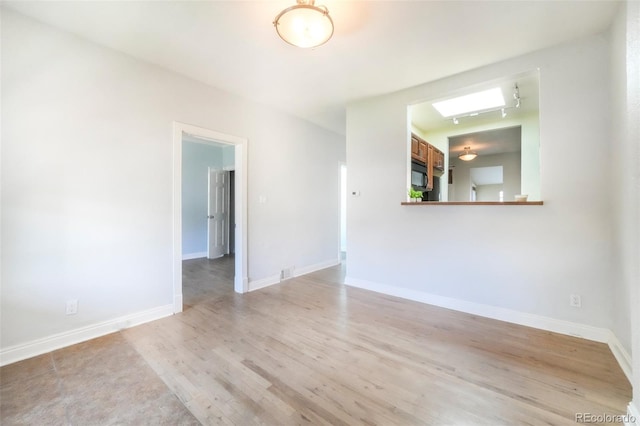22 E Bayaud Ave, Denver, CO 80209 - spare room featuring light wood-style flooring and baseboards