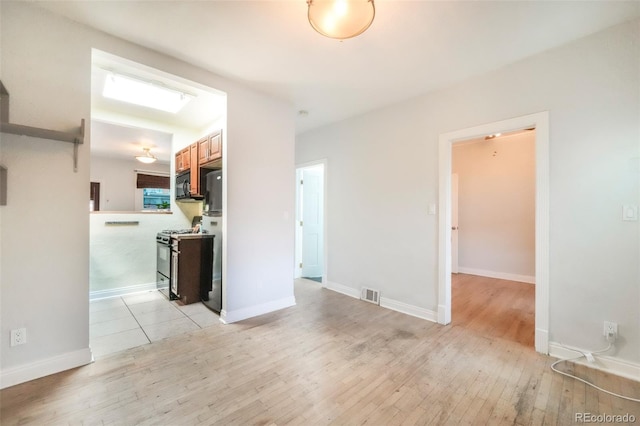 22 E Bayaud Ave, Denver, CO 80209 - spare room featuring light wood-type flooring and baseboards