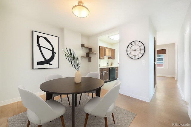 22 E Bayaud Ave, Denver, CO 80209 - dining space featuring light wood-style flooring and baseboards
