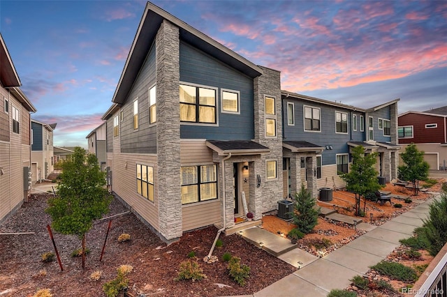 9279 Merino Ct Unit D, Littleton, CO 80125 - view of front facade featuring stone siding and central AC unit