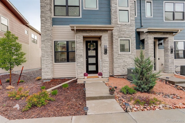 9279 Merino Ct Unit D, Littleton, CO 80125 - entrance to property featuring stone siding and central AC