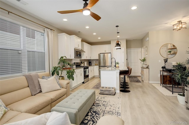 9279 Merino Ct Unit D, Littleton, CO 80125 - living room featuring light wood-style floors, ceiling fan, recessed lighting, and baseboards