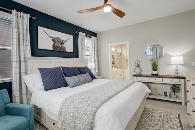 9279 Merino Ct Unit D, Littleton, CO 80125 - bedroom featuring light colored carpet, ensuite bathroom, and a ceiling fan