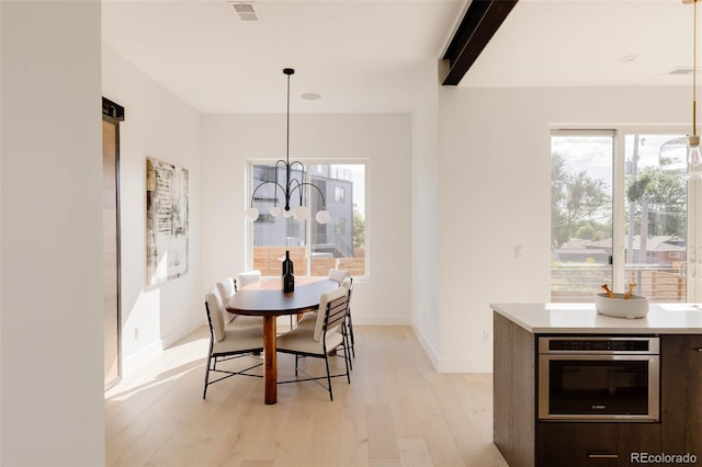 16133 W 14th Ave, Golden, CO 80401 - dining space with beam ceiling, light hardwood / wood-style flooring, and a notable chandelier