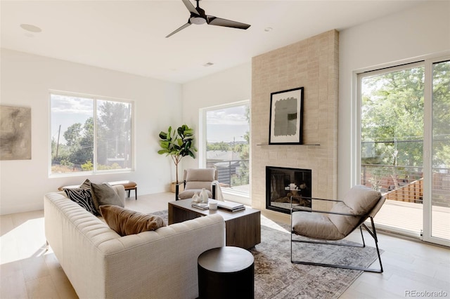 16133 W 14th Ave, Golden, CO 80401 - living room featuring a fireplace, light hardwood / wood-style floors, and ceiling fan