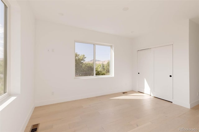16133 W 14th Ave, Golden, CO 80401 - unfurnished bedroom with light hardwood / wood-style flooring and a closet