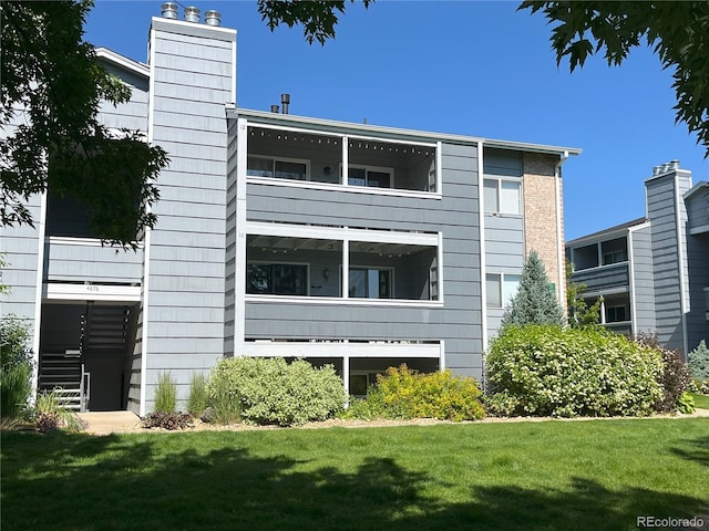 4676 White Rock Cir Unit 12, Boulder, CO 80301 - back of house with a balcony, a yard, and a chimney