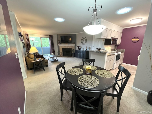 4676 White Rock Cir Unit 12, Boulder, CO 80301 - dining room with light carpet, a tile fireplace, and ornamental molding