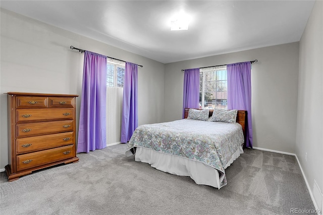 891 Ursula St, Aurora, CO 80011 - bedroom with multiple windows, carpet floors, and baseboards