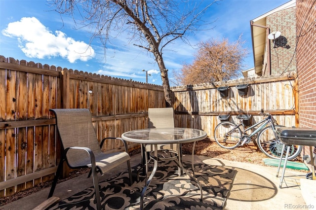 view of patio / terrace featuring fence