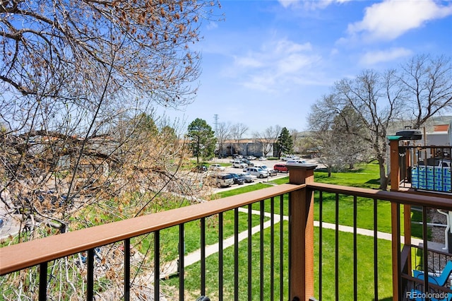 wooden terrace featuring a lawn