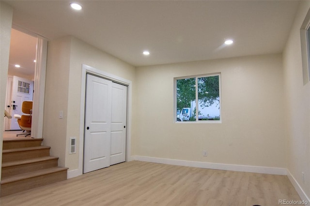 2441 W 55th Ave, Denver, CO 80221 - unfurnished bedroom with light wood-style floors, recessed lighting, baseboards, and a closet