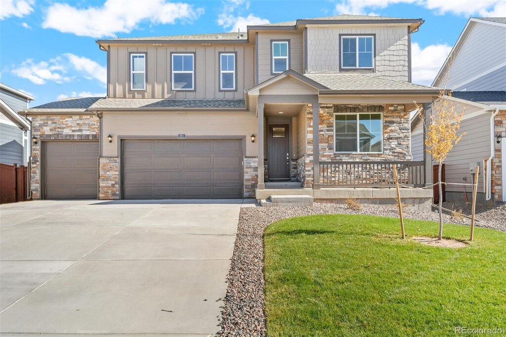 13489 Valentia Pl, Thornton, CO 80602 - view of front facade with driveway, covered porch, a shingled roof, a front lawn, and a garage