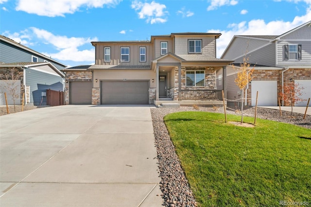 view of front facade featuring a front lawn, concrete driveway, covered porch, stone siding, and an attached garage