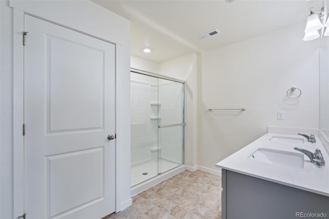 full bathroom with a shower stall, baseboards, visible vents, and a sink