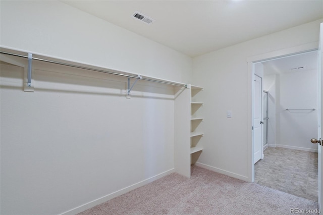 spacious closet with visible vents and carpet flooring