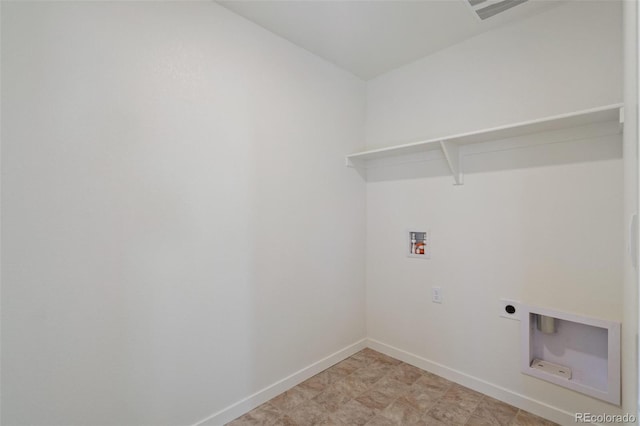 laundry area featuring laundry area, hookup for a washing machine, electric dryer hookup, and baseboards