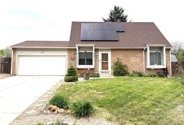 4383 S Eagle Cir, Aurora, CO 80015 - view of front of property with brick siding, a garage, driveway, and roof mounted solar panels