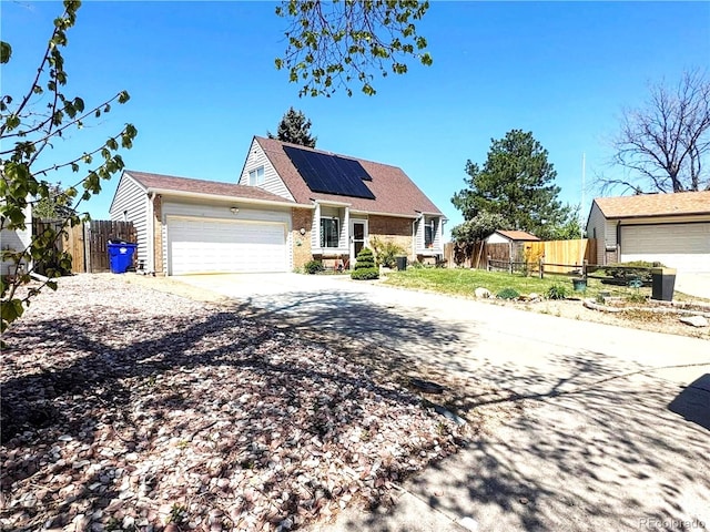 4383 S Eagle Cir, Aurora, CO 80015 - view of front facade with an attached garage, concrete driveway, roof mounted solar panels, and brick siding