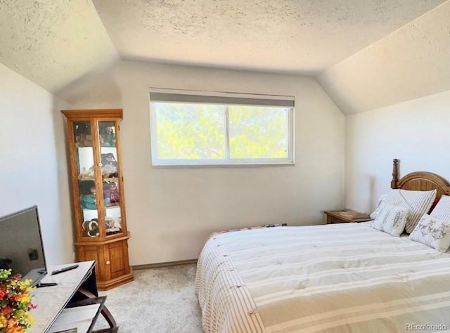 4383 S Eagle Cir, Aurora, CO 80015 - bedroom featuring vaulted ceiling, light carpet, and a textured ceiling